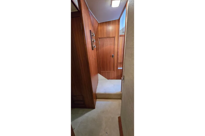Slide: The Image of Interior hallway of 1984 Bertram 42 Flybridge Motor Yacht with wood paneling. - 31