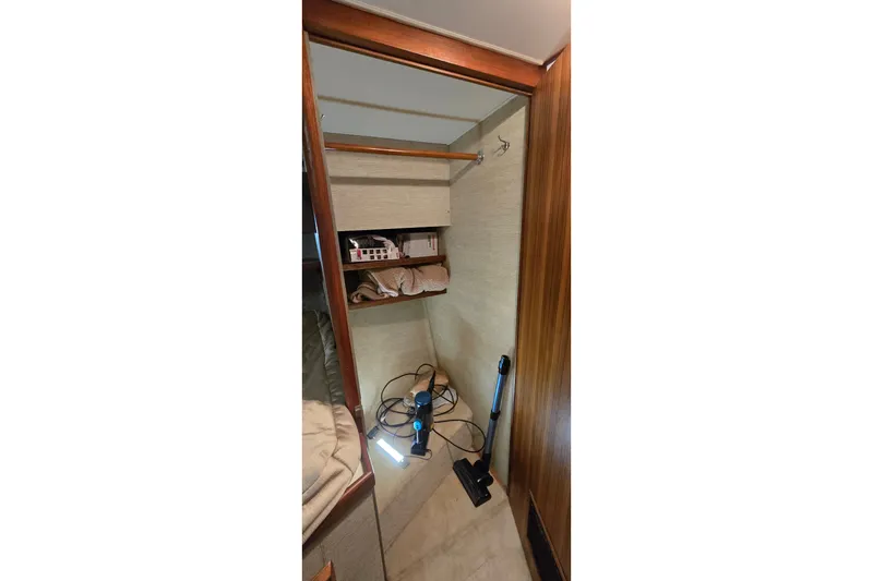 Slide: The Image of Interior closet of 1984 Bertram 42 Flybridge Motor Yacht with shelves and cleaning equipment. - 29
