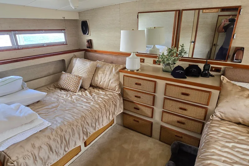 Slide: The Image of Luxurious cabin interior of 1984 Bertram 42 Flybridge Motor Yacht with elegant bedding and decor. - 40
