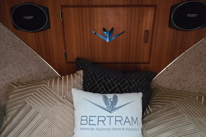 Slide: The Image of Interior of 1984 Bertram 42 Flybridge Motor Yacht with decorative pillows and wood paneling. - 28
