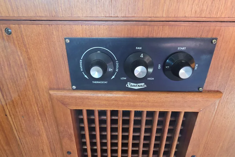 Slide: The Image of Cruisair thermostat controls on 1984 Bertram 42 Flybridge Motor Yacht, wooden panel background. - 44
