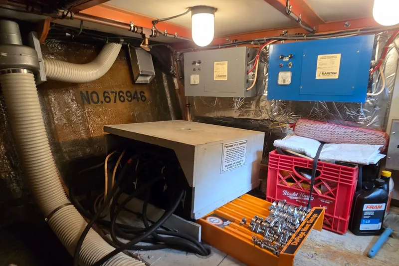 Slide: The Image of Engine room of a 1984 Bertram 42 Flybridge Motor Yacht with electrical panels and maintenance tools. - 51