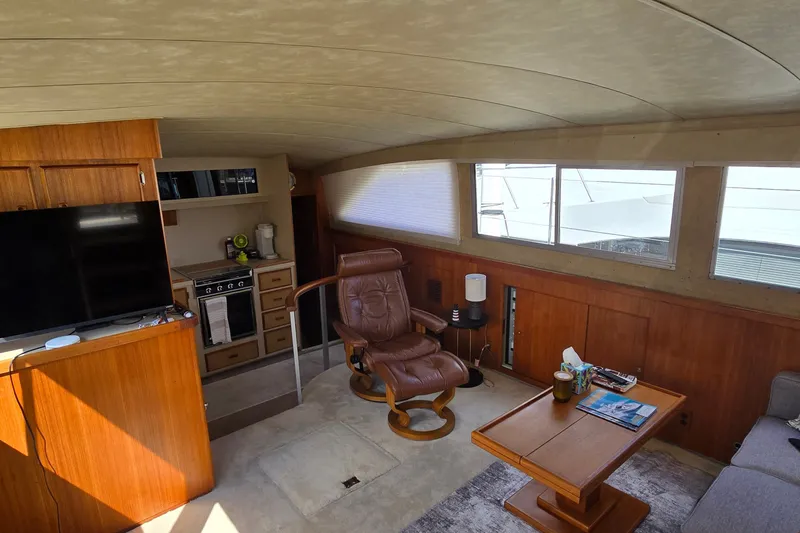 Slide: The Image of Interior of 1984 Bertram 42 Flybridge Motor Yacht with cozy seating and modern amenities. - 16