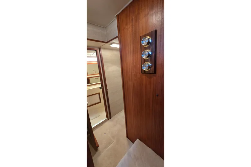 Slide: The Image of Interior hallway of 1984 Bertram 42 Flybridge Motor Yacht with wood paneling and gauges. - 22