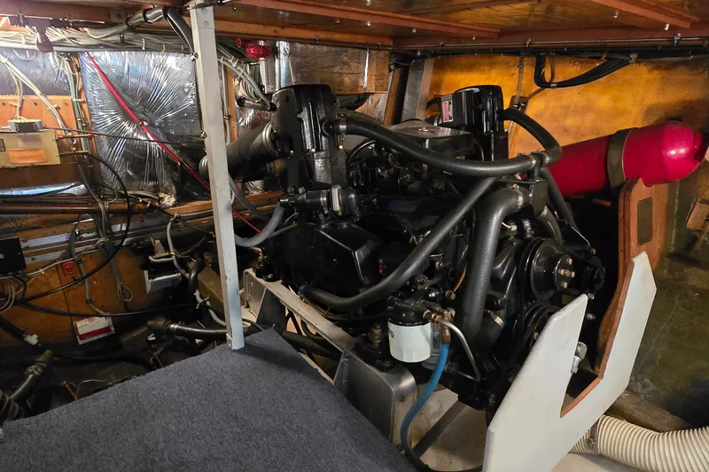 Slide: The Image of Engine room of a 1984 Bertram 42 Flybridge Motor Yacht, showcasing mechanical components. - 52