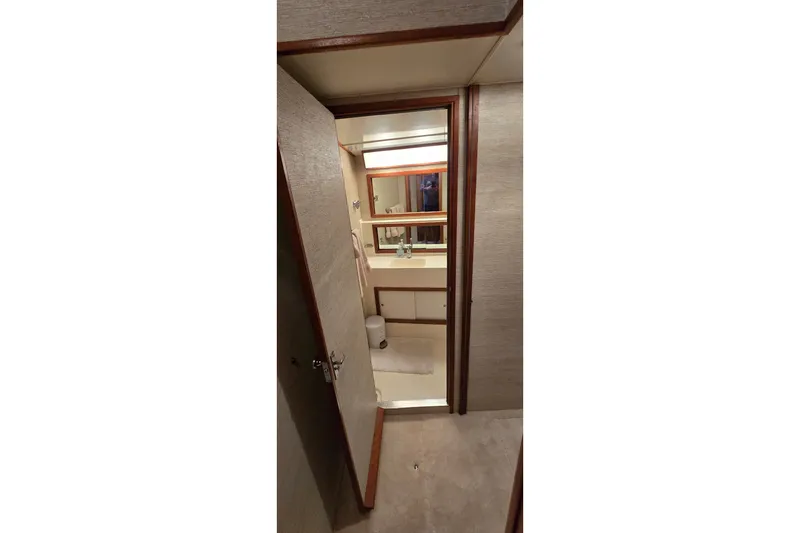 Slide: The Image of Interior view of 1984 Bertram 42 Flybridge Motor Yacht bathroom with mirror and sink. - 23