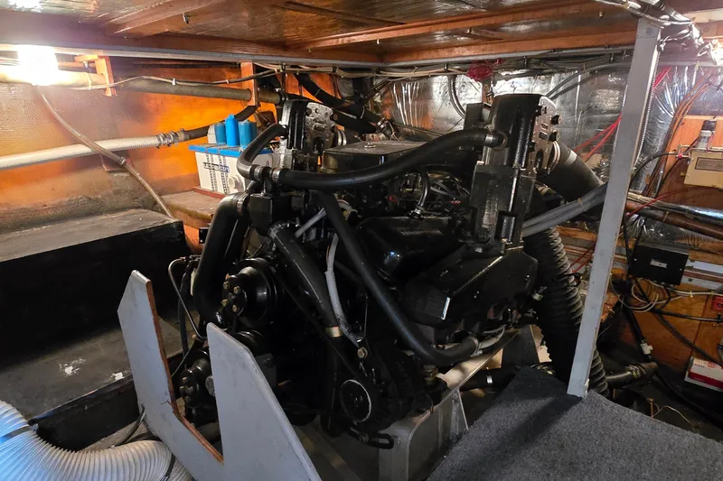 Slide: The Image of Engine room of a 1984 Bertram 42 Flybridge Motor Yacht, showcasing mechanical components. - 53