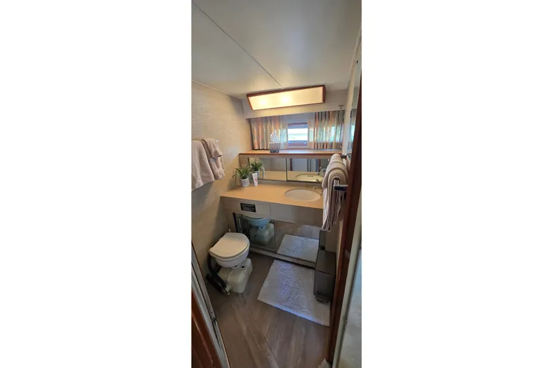 Slide: The Image of Bathroom interior of 1984 Bertram 42 Flybridge Motor Yacht, featuring sink, toilet, and mirror. - 37