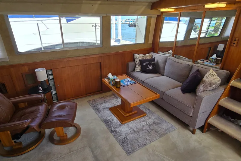 Slide: The Image of Interior of 1984 Bertram 42 Flybridge Motor Yacht with cozy seating and wooden accents. - 17