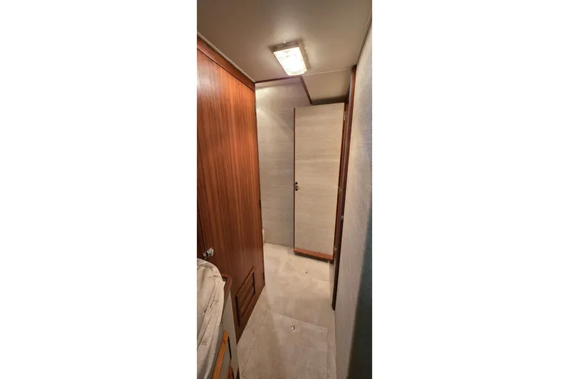 Slide: The Image of Interior hallway of 1984 Bertram 42 Flybridge Motor Yacht with wooden paneling. - 30