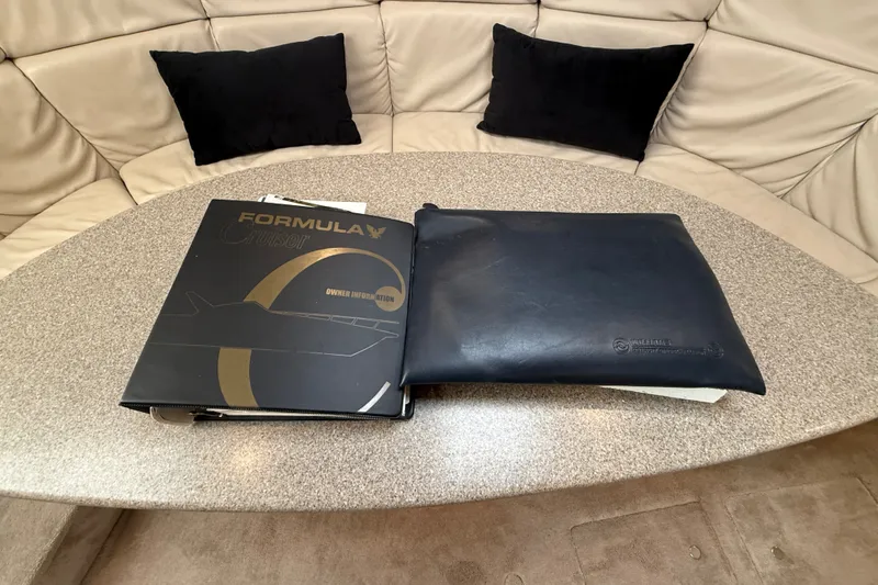 Slide: The Image of Owner's manual for 2000 Formula 41 Performance Cruiser on a beige cushioned table. - 57
