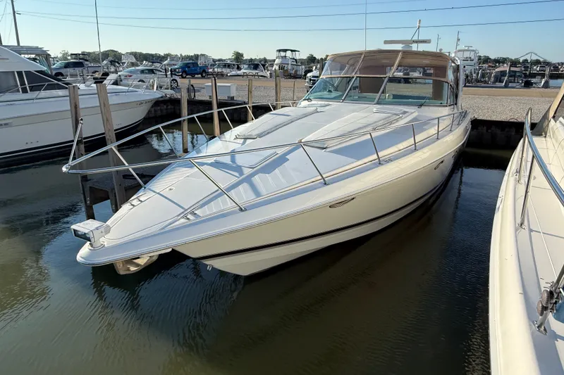 Slide: The Image of 2000 Formula 41 Performance Cruiser docked at marina, sleek design, white exterior. - 4