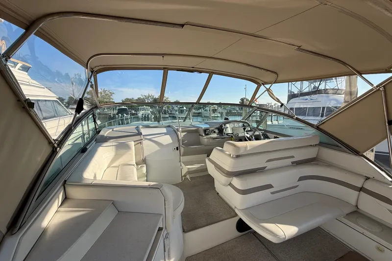 Slide: The Image of Interior of a 2000 Formula 41 Performance Cruiser with beige seating and helm. - 9