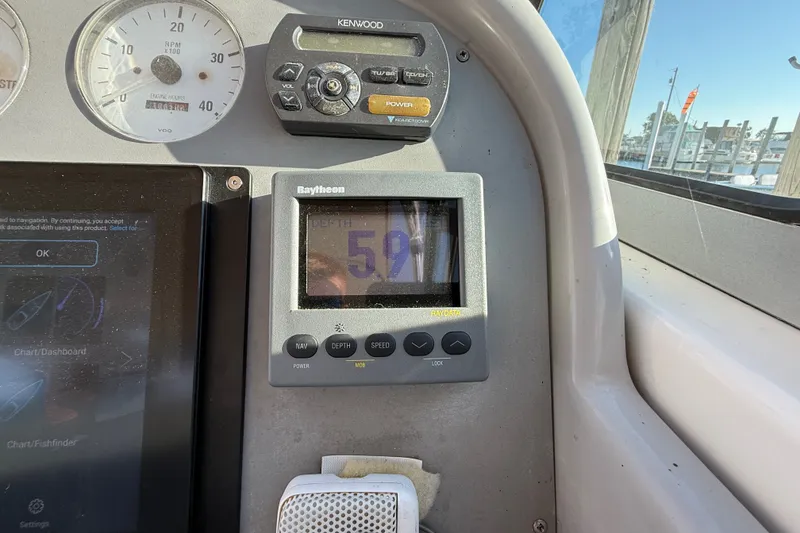 Slide: The Image of Control panel of a 2000 Formula 41 Performance Cruiser with depth gauge and radio. - 31