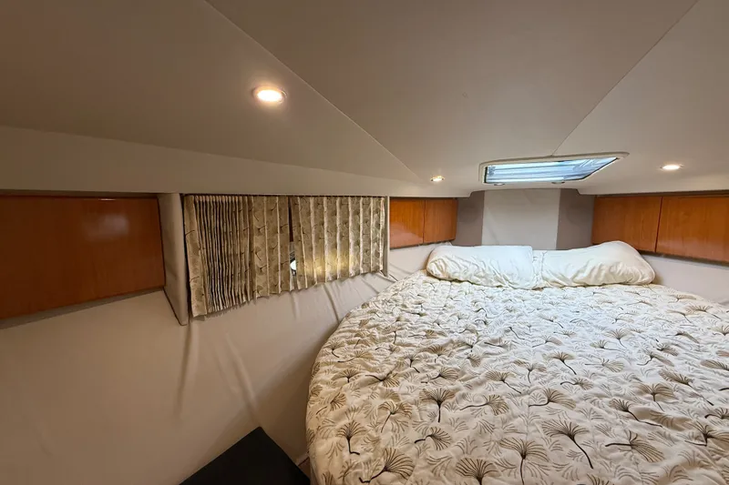 Slide: The Image of Cozy cabin interior of 2000 Formula 41 Performance Cruiser with bed and overhead lighting. - 51
