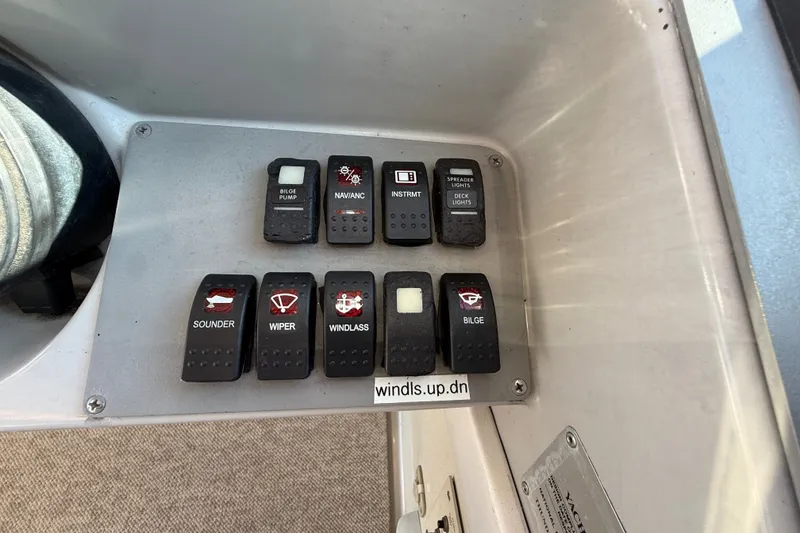 Slide: The Image of Control panel of a 2000 Formula 41 Performance Cruiser with labeled switches. - 33