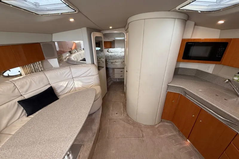 Slide: The Image of Interior of a 2000 Formula 41 Performance Cruiser with modern kitchen and seating area. - 37