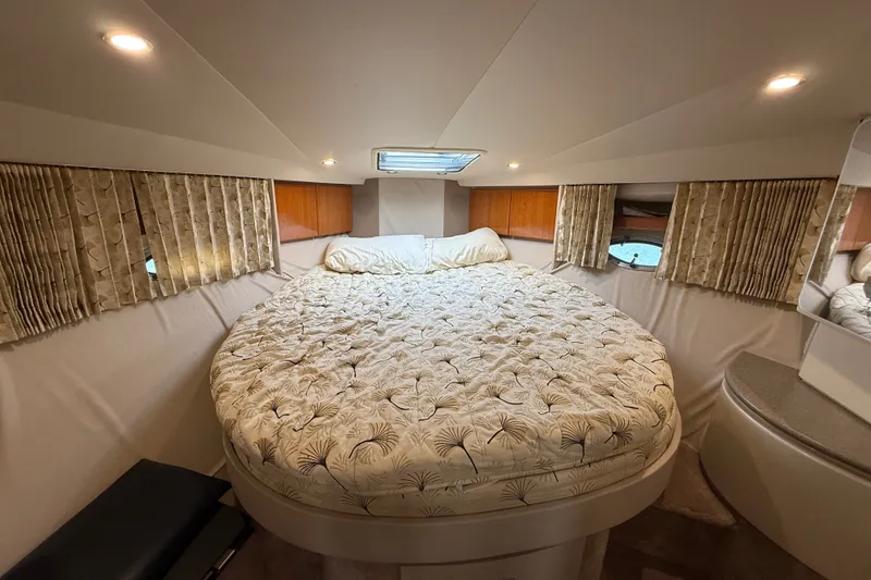 Slide: The Image of Cozy cabin interior of 2000 Formula 41 Performance Cruiser with plush bedding and ambient lighting. - 49