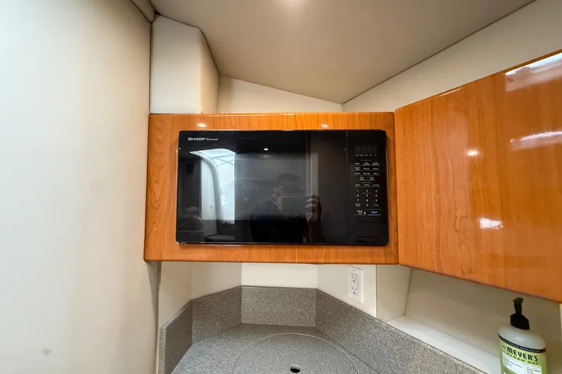 Slide: The Image of Microwave in 2000 Formula 41 Performance Cruiser kitchen with wooden cabinetry. - 46