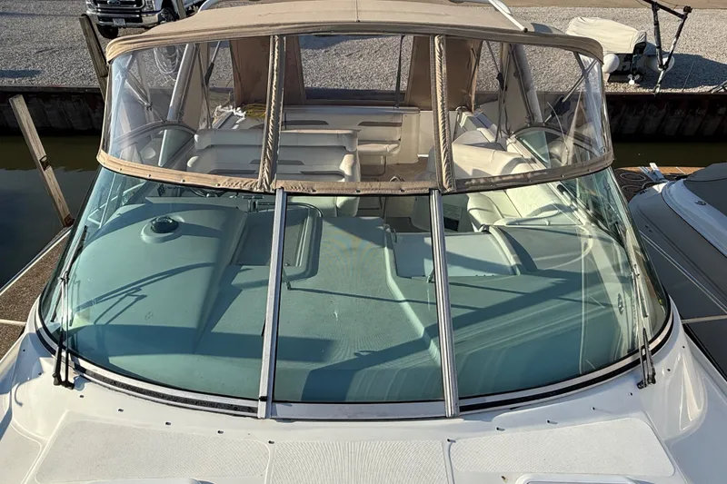 Slide: The Image of 2000 Formula 41 Performance Cruiser with tan canopy and spacious deck, docked at marina. - 6