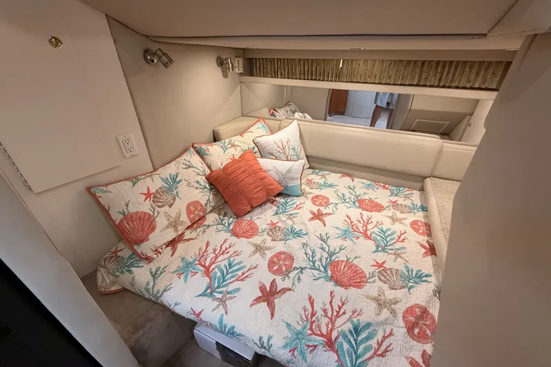 Slide: The Image of Cozy cabin interior of 2000 Formula 41 Performance Cruiser with nautical-themed bedding. - 42