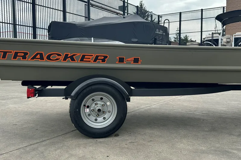 The Image of 2027 Tracker Grizzly 14 Jon boat on trailer, parked outdoors. - 0