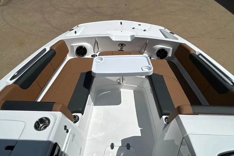 Slide: The Image of 2027 Tahoe 2150 boat interior with brown seating and white table. - 7