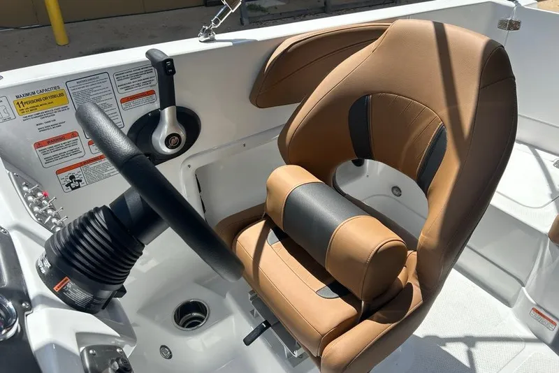Slide: The Image of Steering area of a 2027 Tahoe 2150 boat with tan and black seating. - 5