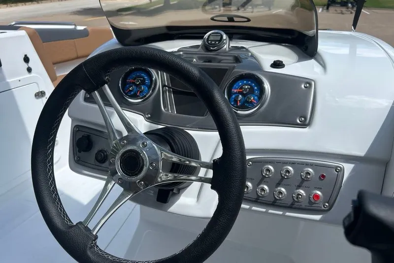Slide: The Image of Steering console of a 2027 Tahoe 2150 boat with gauges and controls. - 3