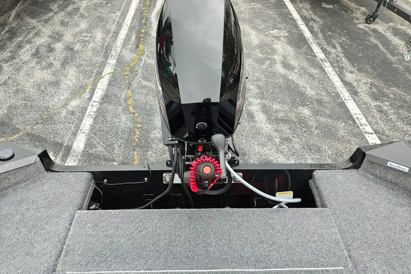 Slide: The Image of 2027 Tracker Super Guide V-16 T boat engine, parked on textured pavement. - 27