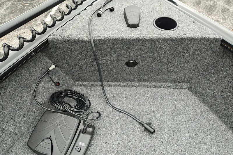 Slide: The Image of 2027 Tracker Super Guide V-16 T boat interior with trolling motor pedal and wiring. - 24