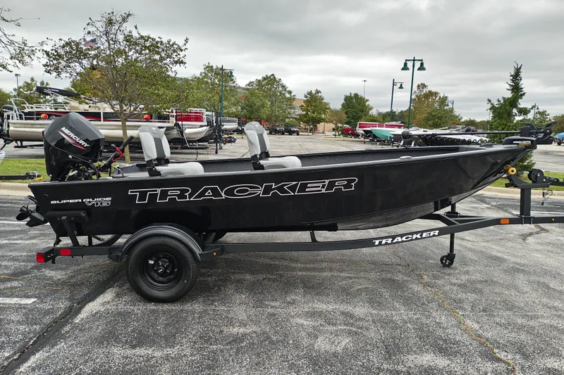 The Image of 2027 Tracker Super Guide V-16 T boat on trailer in parking lot. - 2