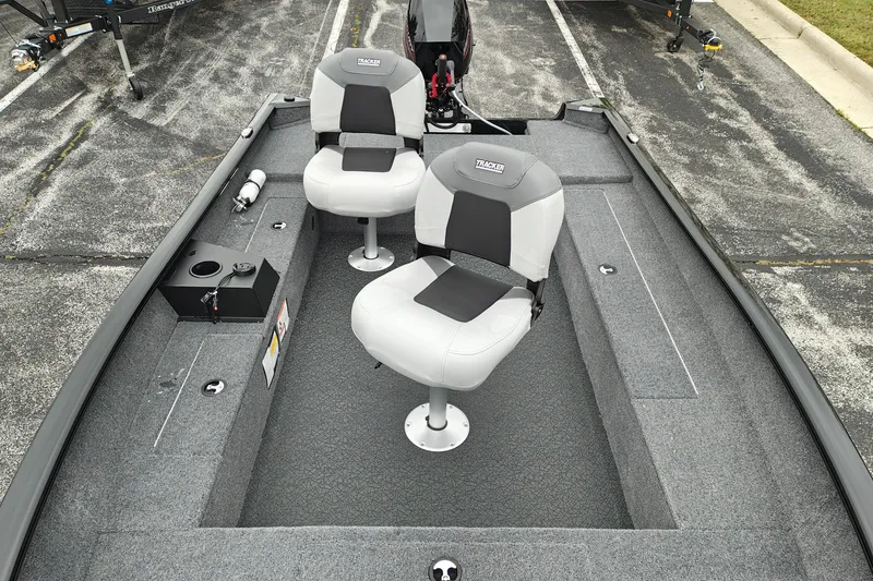Slide: The Image of 2027 Tracker Super Guide V-16 T boat interior with two seats and carpeted flooring. - 25