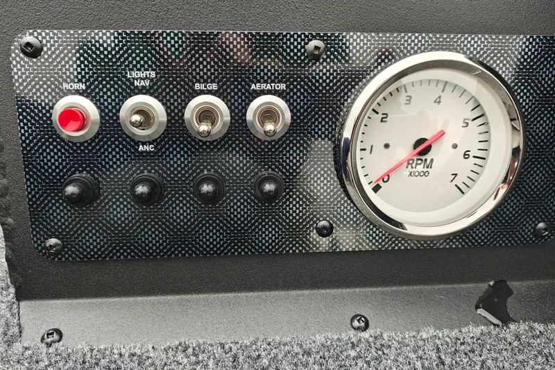 Slide: The Image of Control panel of 2027 Tracker Super Guide V-16 T with switches and RPM gauge. - 15