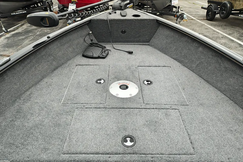 Slide: The Image of 2027 Tracker Super Guide V-16 T boat interior with carpeted deck and storage compartments. - 19