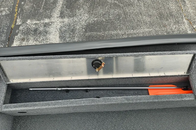 Slide: The Image of Storage compartment of 2027 Tracker Super Guide V-16 T boat with fishing rod. - 26