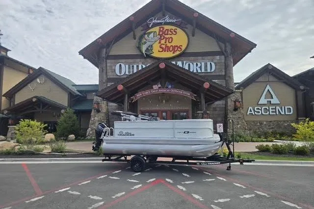 The Image of 2027 Sun Tracker Party Barge 16 DLX pontoon boat outside Bass Pro Shops. - 0