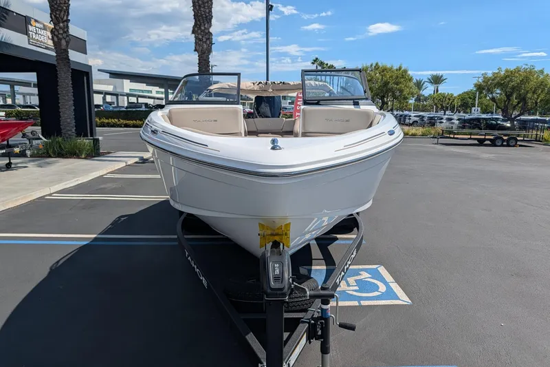 Slide: The Image of 2027 Tahoe 210 S boat on trailer in sunny dealership parking lot. - 4