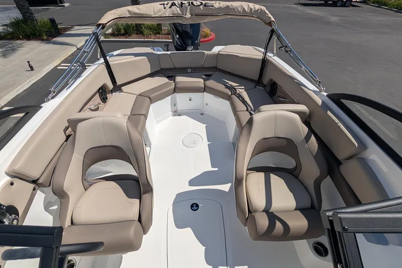 Slide: The Image of 2027 Tahoe 210 S boat interior with beige seating and spacious layout. - 12