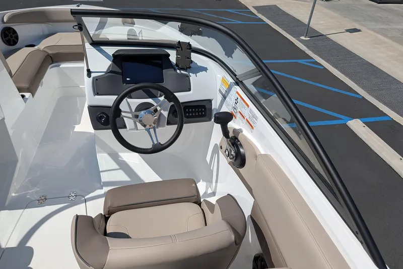 Slide: The Image of Interior view of 2027 Tahoe 210 S boat, featuring steering wheel and dashboard controls. - 9