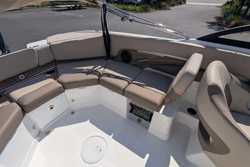 Slide: The Image of Interior of 2027 Tahoe 210 S boat with beige seating and storage compartments. - 10