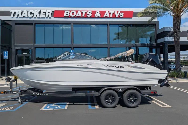 Slide: The Image of 2027 Tahoe 210 S boat on trailer outside Tracker Boats & ATVs dealership. - 3