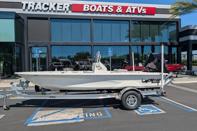 Slide: The Image of 2026 Mako 18 Pro Skiff boat on trailer outside Tracker Boats dealership. - 4