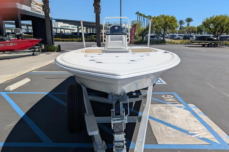 Slide: The Image of 2026 Mako 18 Pro Skiff boat on trailer in parking lot, sunny day. - 1