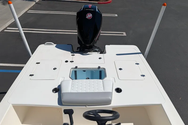 Slide: The Image of 2026 Mako 18 Pro Skiff boat with outboard motor, viewed from above in parking lot. - 6