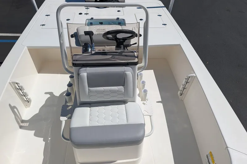 Slide: The Image of 2026 Mako 18 Pro Skiff boat interior with steering console and seating. - 8