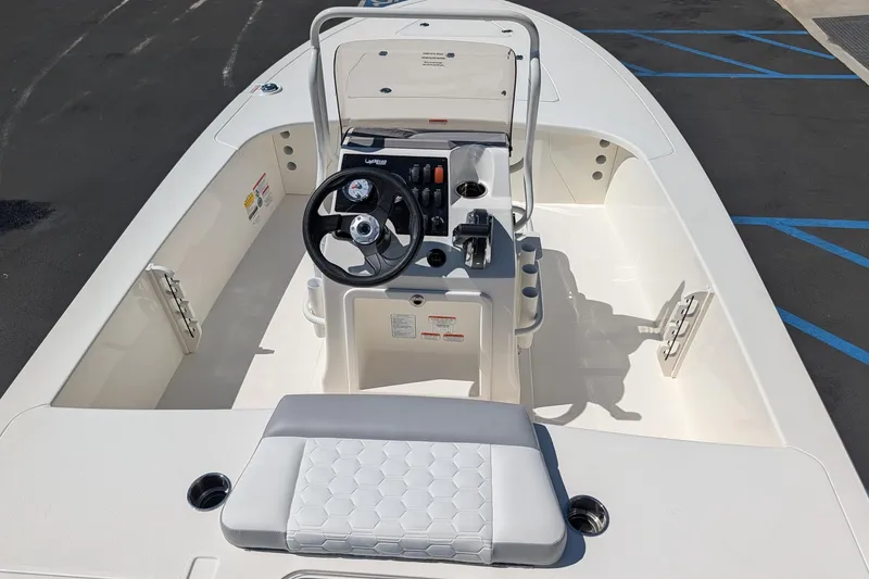 Slide: The Image of 2026 Mako 18 Pro Skiff boat interior with steering console and seating. - 7