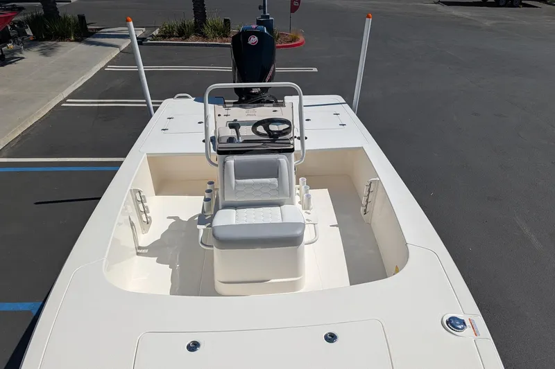 Slide: The Image of 2026 Mako 18 Pro Skiff boat with center console in a parking lot. - 10