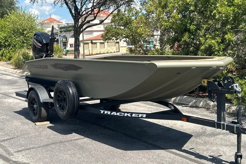 The Image of 2027 Tracker Grizzly 1650 T Prairie Wings Edition boat on trailer, parked outdoors. - 0