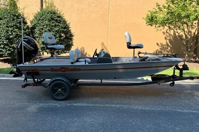 The Image of 2027 Tracker Bass Tracker Classic Limited boat on trailer, parked outdoors. - 0
